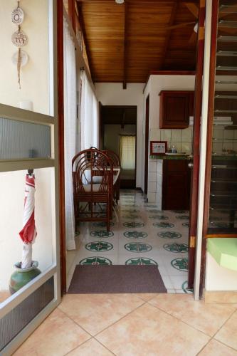 a room with a kitchen with a table and a floor at Bungalows Sanlaz in Barrio Jesús