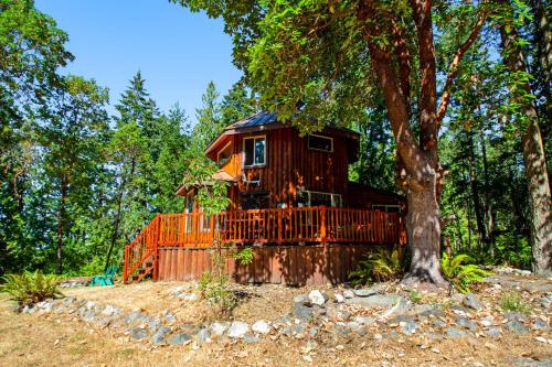 a tree house in the middle of a forest at Gummy Bear in Sequim