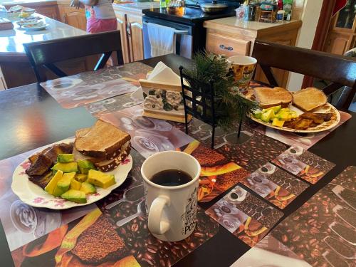 a table with two plates of food and a cup of coffee at Mountain Palace in Guarata