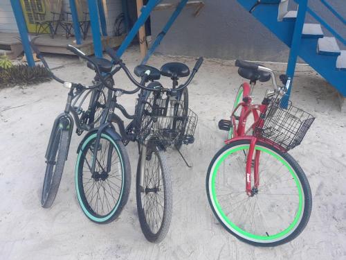 three bikes parked next to each other on the beach at Smalls Cozy Rest with dock in Alice Town