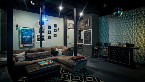 a living room with a couch and a table at 160inch Home Movie Theater- Great for movie night! in Omaha
