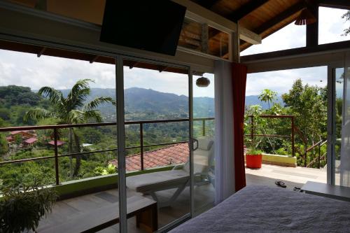 a bedroom with a view of the mountains at Bungalows Sanlaz in Barrio Jesús