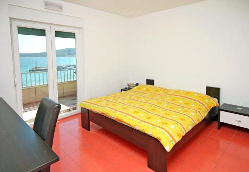 a bedroom with a bed and a view of the ocean at Family friendly seaside apartments Slatine, Ciovo - 1096 in Slatine