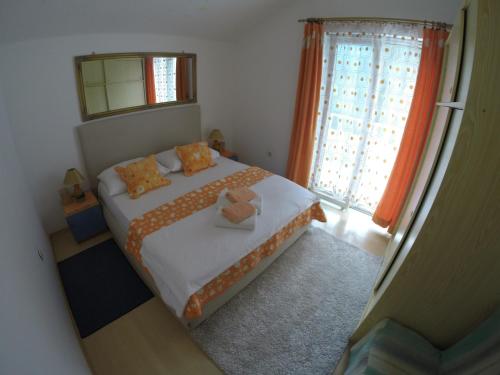 a small bedroom with a bed with two teddy bears on it at Apartments by the sea Slatine, Ciovo - 1098 in Slatine