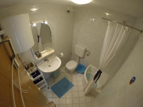 a bathroom with a sink and a toilet and a mirror at Apartments by the sea Slatine, Ciovo - 1098 in Slatine
