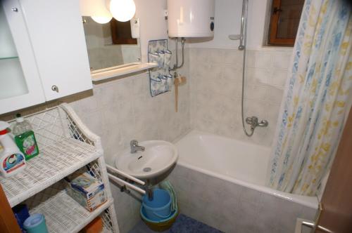 a bathroom with a sink and a toilet and a shower at Apartments by the sea Vinisce, Trogir - 1166 in Vinišće