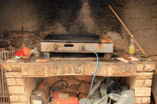 an old stove sitting on top of a stone fireplace at Double Room Mandre 3557b in Kolan