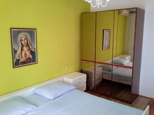 a bedroom with a bed and a painting on the wall at Apartment Zubovici 4125d in Zubovići