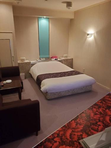 a bedroom with a large bed and a couch at Airport 