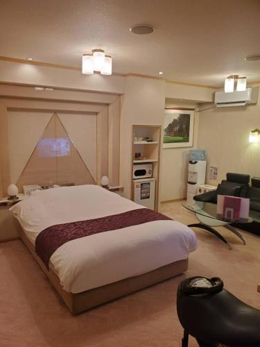 a bedroom with a large bed and a couch at Airport 