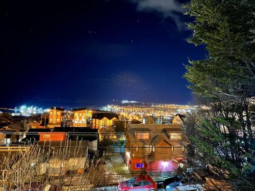 a view of a city at night with lights at Casa Austral vista única de toda la ciudad de Ushuaia in Ushuaia