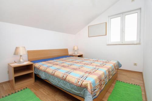 a bedroom with a bed and a window at Apartments by the sea Molunat, Dubrovnik - 2137 in Molunat