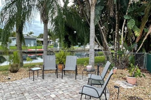 a group of chairs and tables in a patio at Heated Pool Paradise, Gulf Access, Pet Friendly in Port Charlotte