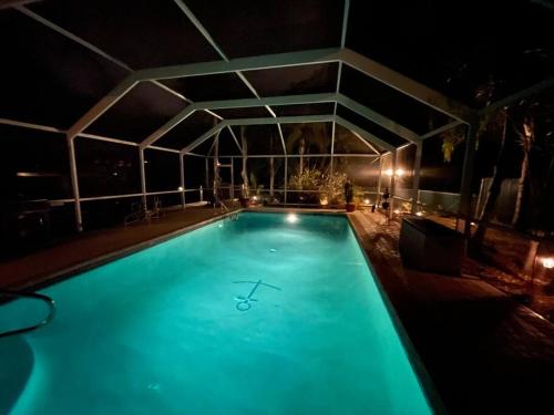 a large swimming pool at night with aperature at Heated Pool Paradise, Gulf Access, Pet Friendly in Port Charlotte