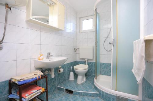 a bathroom with a sink and a toilet and a shower at Apartments with a parking space Slatine, Ciovo - 2030 in Trogir