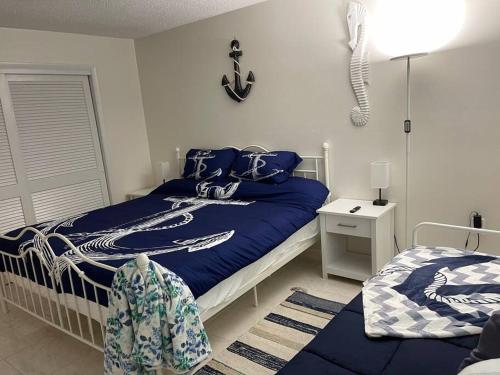 a bedroom with a bed with a anchor on the wall at Heated Pool Paradise, Gulf Access, Pet Friendly in Port Charlotte