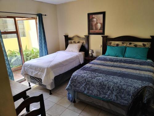 Ένα ή περισσότερα κρεβάτια σε δωμάτιο στο El Ático Guatemala