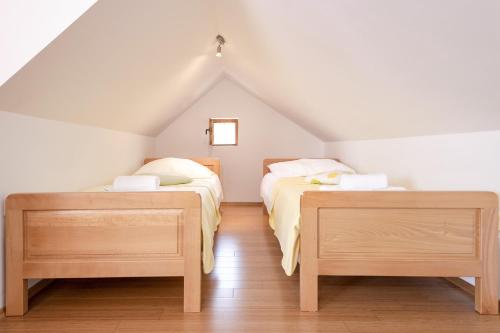a attic bedroom with two beds and two tables at Studio Zavala 2061a in Zavala