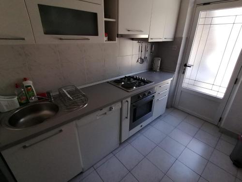 a kitchen with a sink and a stove top oven at Apartments with a parking space Jelsa, Hvar - 2059 in Jelsa