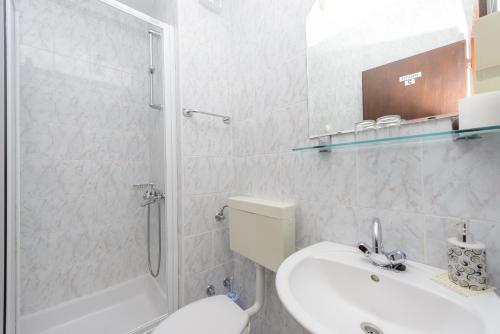 a bathroom with a sink and a toilet and a shower at Apartments and rooms by the sea Zaton Veliki, Dubrovnik - 2110 in Zaton