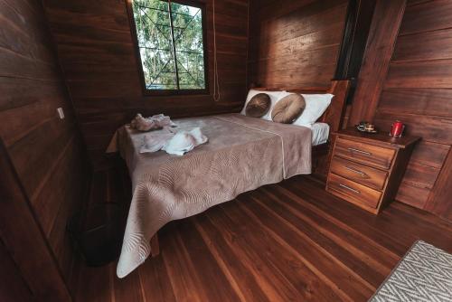 a bedroom with two dogs laying on a bed at Cabañas Don Ramiro in Colonia Dos Ríos
