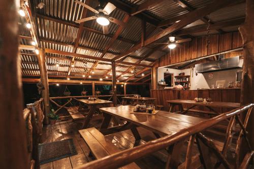 a restaurant with wooden tables and a ceiling at Cabañas Don Ramiro in Colonia Dos Ríos