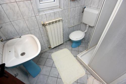 a bathroom with a sink and a toilet at Apartments with a parking space Peroj, Fazana - 2234 in Peroj