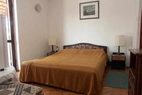 a bedroom with a bed and two lamps on tables at Rooms with a parking space Rovinj - 2245 in Rovinj