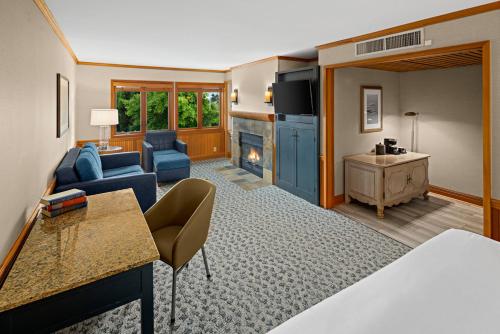 a hotel room with a bed and a living room with a fireplace at Semiahmoo Resort and Spa in Blaine