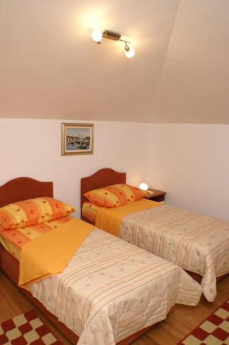 a bedroom with two beds in a room at Apartments by the sea Supetar, Brac - 4274 in Supetar