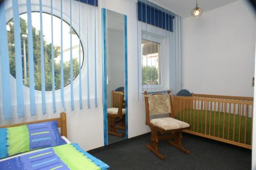 a bedroom with a bed and a chair and a mirror at Apartment Mandre 4098d in Mandre