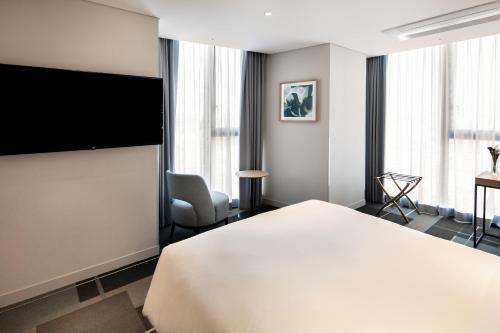 Uma TV ou centro de entretenimento em G3 Hotel Chungmuro