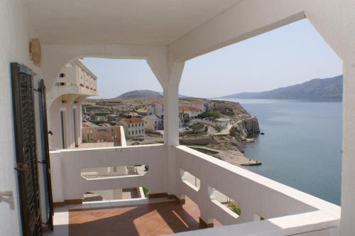a view of the ocean from a balcony of a house at Apartments and rooms by the sea Zubovici, Pag - 4065 in Zubovići