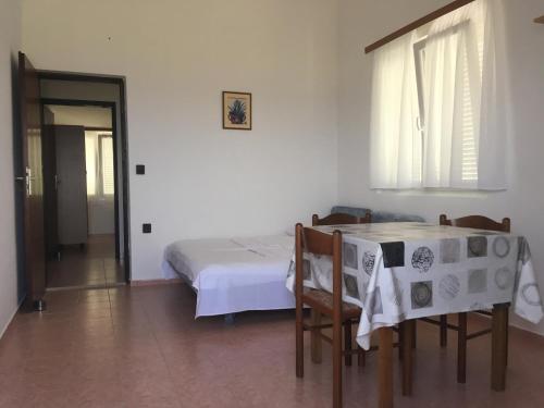 a bedroom with a bed and a table and chairs at Apartment Potocnica 4096f in Stara Novalja