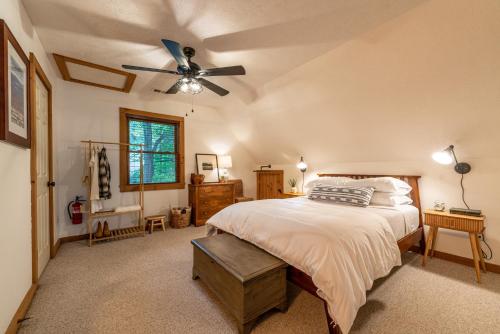 a bedroom with a bed and a ceiling fan at Creekside Cabin - Seven Devils,NC - Pet-Friendly, Close to Hiking & Fishing, and Family Games! in Seven Devils