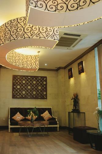 a living room with a couch and a ceiling at The Visala Boutique Suites Seminyak in Seminyak