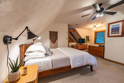 a bedroom with a bed and a ceiling fan at Creekside Cabin - Seven Devils,NC - Pet-Friendly, Close to Hiking & Fishing, and Family Games! in Seven Devils