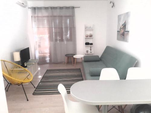 a living room with a couch and a table and chairs at Apartments and rooms by the sea Sumpetar, Omis - 2099 in Jesenice
