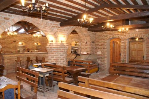 a restaurant with wooden tables and benches in a building at Apartments and rooms with parking space Biograd na Moru, Biograd - 4305 in Biograd na Moru