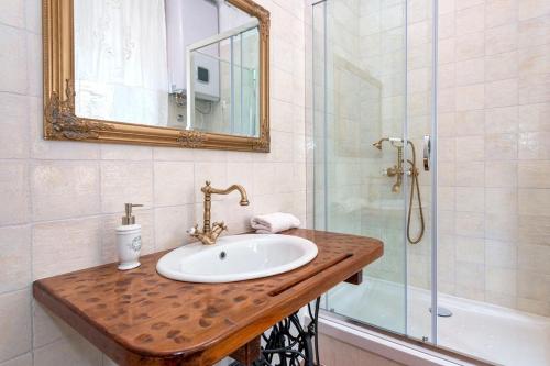 a bathroom with a sink and a shower with a mirror at Seaside apartments with a swimming pool Jelsa, Hvar - 2067 in Jelsa