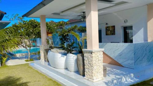 a villa with a swimming pool and a house at Daniswara Villa in Uluwatu