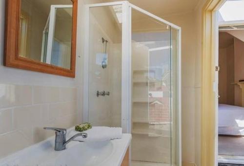 a bathroom with a sink and a shower at Cosy Glebe cottage - walk to central Hobart in Hobart