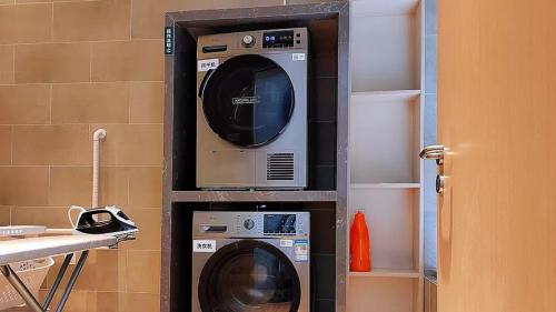 a washer and dryer in a shelf in a kitchen at Holiday Inn Shanghai Dishui Lake by IHG in Nanhui