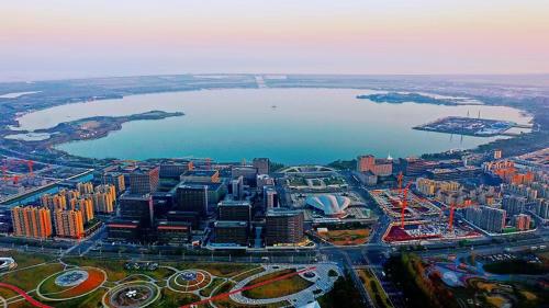 an aerial view of a city with a body of water at Holiday Inn Shanghai Dishui Lake by IHG in Nanhui