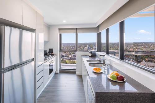 a kitchen with a counter with fruits on it at Meriton Suites Church Street, Parramatta in Sydney