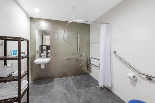 a bathroom with a shower and a sink at Meriton Suites Church Street, Parramatta in Sydney
