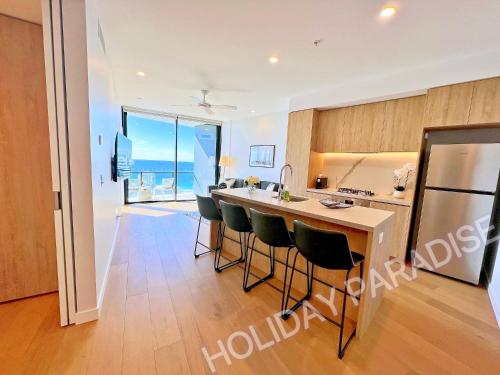 a view of a kitchen and living room of a apartment at Luxury S Casino Residences Broadbeach - Holiday Paradise in Gold Coast