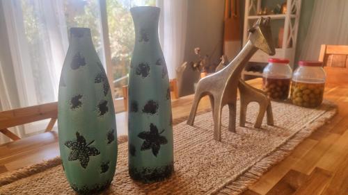 a group of three vases sitting on a table at Olives in Arad