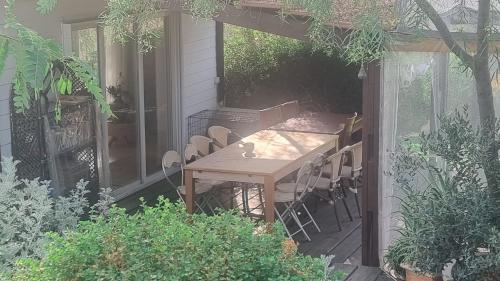 a wooden table and chairs on a patio at Olives in Arad