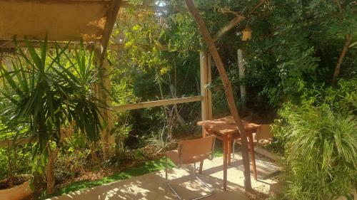 a table and a chair in a garden at Olives in Arad